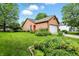 Well-maintained home exterior with a lush front lawn and garden beds at 4646 Rocky Knob Ln, Indianapolis, IN 46254