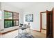Bright home office with hardwood floors, a desk, and a large window showcasing the greenery outside at 4646 Rocky Knob Ln, Indianapolis, IN 46254