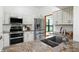 This remodeled kitchen showcases stainless appliances, granite counters, and white cabinets at 4646 Rocky Knob Ln, Indianapolis, IN 46254