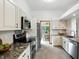 Modern kitchen boasts granite countertops, stainless steel appliances, and sleek white cabinetry at 4646 Rocky Knob Ln, Indianapolis, IN 46254