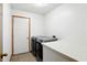A well-lit laundry room with modern washer, dryer, white cabinets, and neutral flooring at 4646 Rocky Knob Ln, Indianapolis, IN 46254