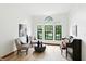 Sunlit living room with large windows, hardwood floors, and comfortable seating at 4646 Rocky Knob Ln, Indianapolis, IN 46254