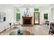 Bright living room boasts a charming fireplace and plenty of natural light from the well-placed windows at 4646 Rocky Knob Ln, Indianapolis, IN 46254