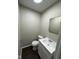 Clean bathroom with white vanity, toilet, and mirror at 5209 Laredo St, Indianapolis, IN 46237