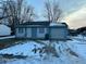 Ranch home with attached garage and snow-covered yard at 5209 Laredo St, Indianapolis, IN 46237