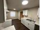 Modern kitchen with white cabinets and dark floors at 5209 Laredo St, Indianapolis, IN 46237