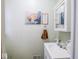 Small bathroom with a sink, toilet and decorative accents at 6004 S Orinoco Ave, Indianapolis, IN 46227