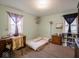 Bedroom with a bed, desk, and plenty of storage at 6004 S Orinoco Ave, Indianapolis, IN 46227