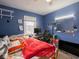 Blue bedroom with a bed, desk, and window at 6004 S Orinoco Ave, Indianapolis, IN 46227