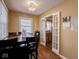 Bright dining area with hardwood floors and French doors leading to kitchen at 6004 S Orinoco Ave, Indianapolis, IN 46227