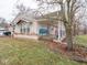 Tan brick ranch house with covered porch and side yard at 6004 S Orinoco Ave, Indianapolis, IN 46227