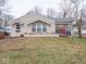 Tan brick ranch house with covered porch and front yard at 6004 S Orinoco Ave, Indianapolis, IN 46227