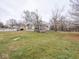 Tan brick ranch home with covered porch and side yard at 6004 S Orinoco Ave, Indianapolis, IN 46227