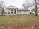 Tan brick ranch house with covered porch and backyard at 6004 S Orinoco Ave, Indianapolis, IN 46227