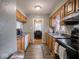 Bright kitchen with wood cabinets, appliances, and vinyl flooring at 6004 S Orinoco Ave, Indianapolis, IN 46227