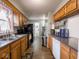 Kitchen with wood cabinets, stainless steel appliances, and a double sink at 6004 S Orinoco Ave, Indianapolis, IN 46227