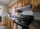 View of kitchen stove, countertops, and wood cabinets at 6004 S Orinoco Ave, Indianapolis, IN 46227