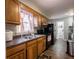 Kitchen boasts wood cabinets, a double sink, and modern appliances at 6004 S Orinoco Ave, Indianapolis, IN 46227