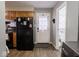 Kitchen with black refrigerator and access to a half bathroom at 6004 S Orinoco Ave, Indianapolis, IN 46227