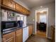 Galley kitchen with wood cabinets, microwave, and dishwasher at 6004 S Orinoco Ave, Indianapolis, IN 46227