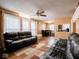 Living room with leather couches, wood floors, and dining area at 6004 S Orinoco Ave, Indianapolis, IN 46227