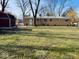 Spacious backyard with a large grassy area and mature trees at 6107 Hazelhatch Dr, Indianapolis, IN 46228
