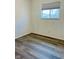 Simple bedroom featuring wood-look floors and window at 6107 Hazelhatch Dr, Indianapolis, IN 46228
