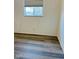 Spacious bedroom with wood-look floors and window at 6107 Hazelhatch Dr, Indianapolis, IN 46228