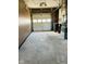 Unfinished garage with overhead door and concrete floor at 6107 Hazelhatch Dr, Indianapolis, IN 46228