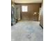 Unfinished garage with concrete floor and water heater at 6107 Hazelhatch Dr, Indianapolis, IN 46228