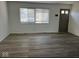 Spacious living room with hardwood floors and large window at 6107 Hazelhatch Dr, Indianapolis, IN 46228