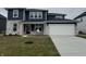 Charming two-story home featuring a two-car garage, brick accents, and a well-manicured lawn at 6322 Stone Side Dr, Plainfield, IN 46168