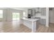 Modern kitchen with gray cabinets, island, and stainless steel appliances at 6322 Stone Side Dr, Plainfield, IN 46168