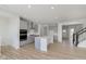Modern kitchen with gray cabinets, island, and stainless steel appliances at 6322 Stone Side Dr, Plainfield, IN 46168
