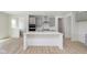 Modern kitchen with gray cabinets, island, and stainless steel appliances at 6322 Stone Side Dr, Plainfield, IN 46168