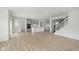Open floor plan boasting a spacious kitchen island and Gathering room with wood-look flooring at 6322 Stone Side Dr, Plainfield, IN 46168