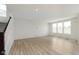 Spacious living area with hardwood floors and multiple windows at 6322 Stone Side Dr, Plainfield, IN 46168