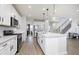 Modern kitchen with white cabinets, stainless steel appliances, and an island at 6345 Stone Side Dr, Plainfield, IN 46168