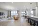Spacious living room with a leather couch, large windows, and a chandelier at 6345 Stone Side Dr, Plainfield, IN 46168