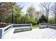 Large white painted wooden back deck offers scenic views of a green, tree-filled yard with built-in benches at 8041 Halyard Way, Indianapolis, IN 46236
