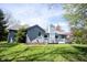 Expansive backyard featuring a well-manicured lawn, a privacy fence, and mature trees, perfect for outdoor enjoyment at 8041 Halyard Way, Indianapolis, IN 46236