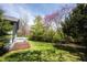 Well-maintained backyard with lush green lawn, mulch bed, and mature trees providing shade and privacy at 8041 Halyard Way, Indianapolis, IN 46236