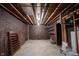 Unfinished basement with exposed ceiling, concrete floor and brick wall at 8041 Halyard Way, Indianapolis, IN 46236