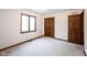 Bedroom with a window, plush carpet, and closet, providing ample storage at 8041 Halyard Way, Indianapolis, IN 46236