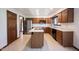 Traditional kitchen featuring an island cooktop, stainless steel appliances, and abundant wooden cabinetry at 8041 Halyard Way, Indianapolis, IN 46236