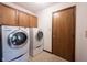 A laundry room featuring a washer and dryer with wood cabinets at 8041 Halyard Way, Indianapolis, IN 46236