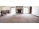 Spacious living room featuring a stone fireplace, sliding glass doors, and natural light at 8041 Halyard Way, Indianapolis, IN 46236