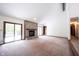Spacious living room featuring a stone fireplace, sliding glass doors, and natural light at 8041 Halyard Way, Indianapolis, IN 46236