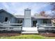 Back exterior of home with a spacious deck, chimney, and sliding glass doors offering seamless indoor-outdoor living at 8041 Halyard Way, Indianapolis, IN 46236