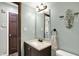 Cozy bathroom featuring a vanity with a cream countertop and a decorative wall sconce at 8072 Foxchase Dr, Indianapolis, IN 46256
